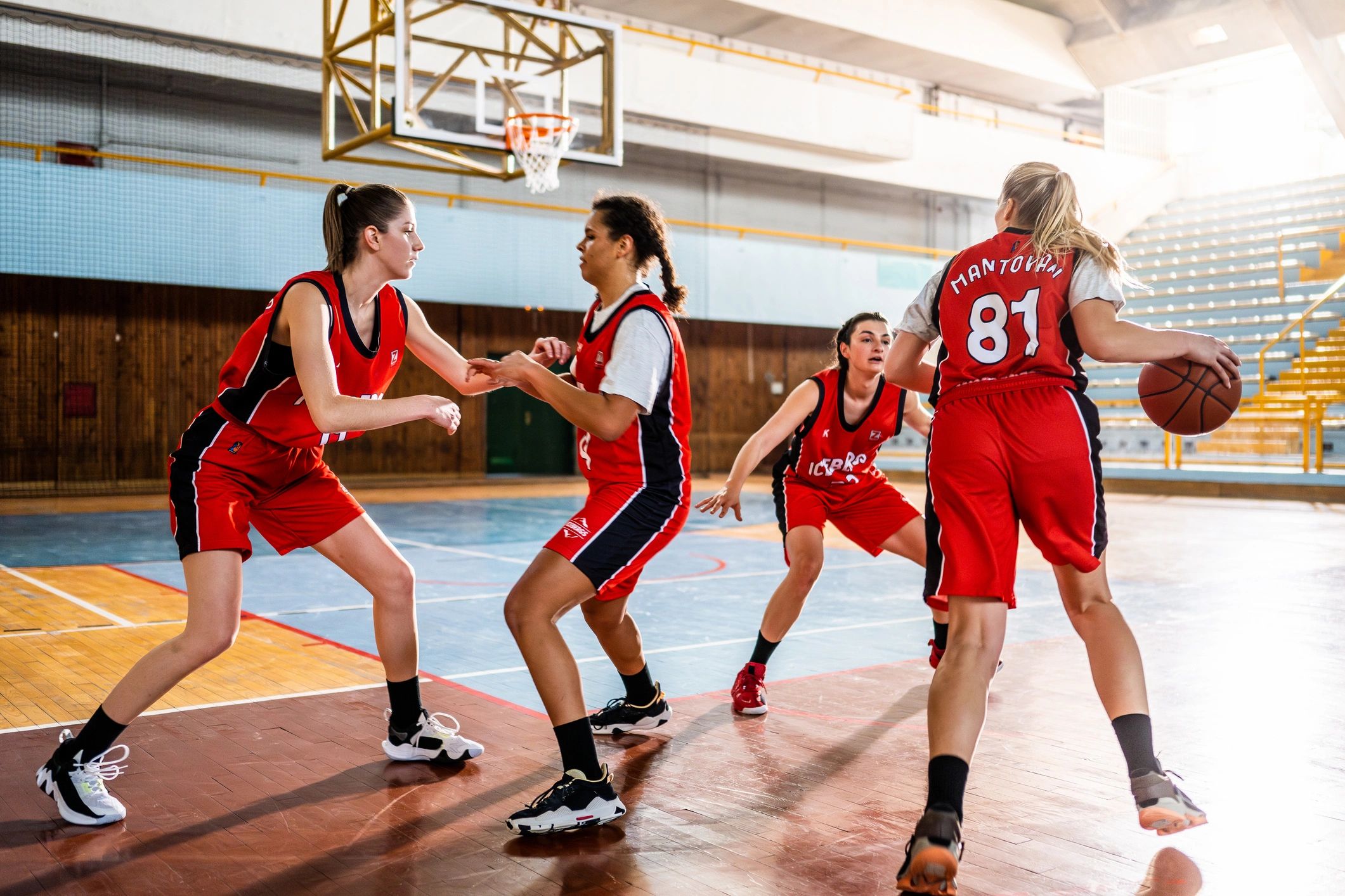 Basketball team practicing on an indoor court