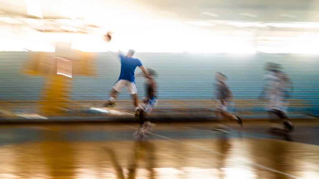Blurred basketball male team training at court
