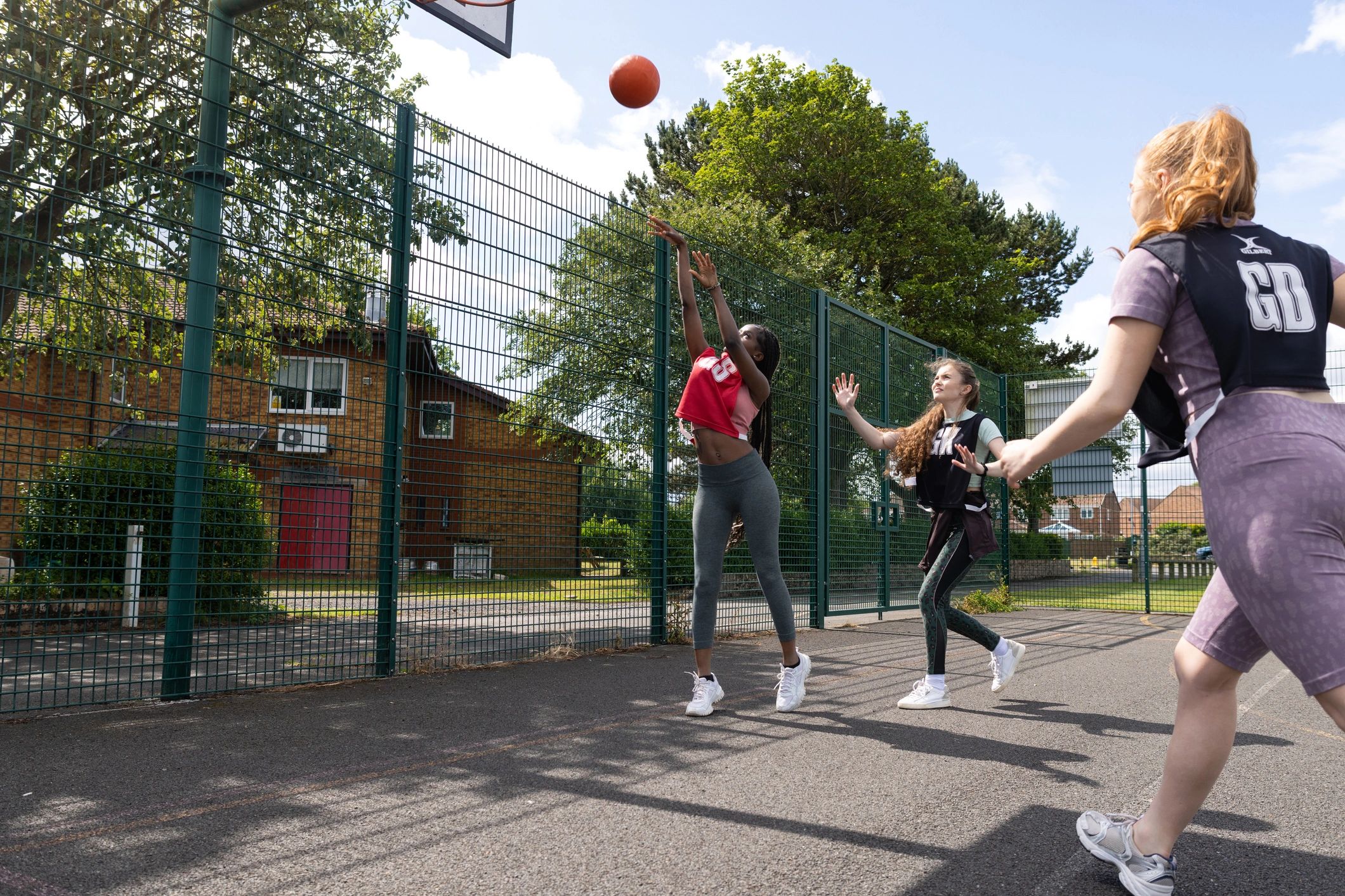 Players working together on an outdoor basketball court